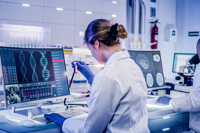 Scientists examines DNA models in modern Neurological Research Laboratory.