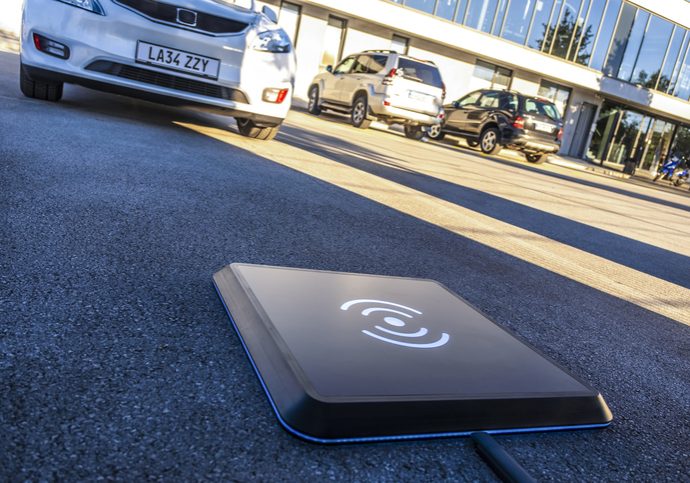 Close-up of wireless car charger on road.